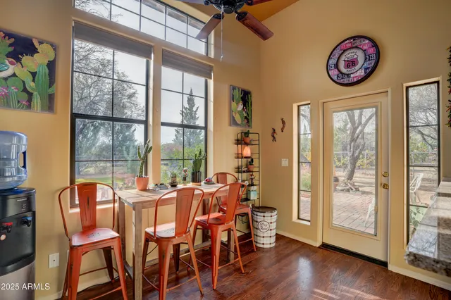 a view of a dining room with furniture a chandelier and wooden floor