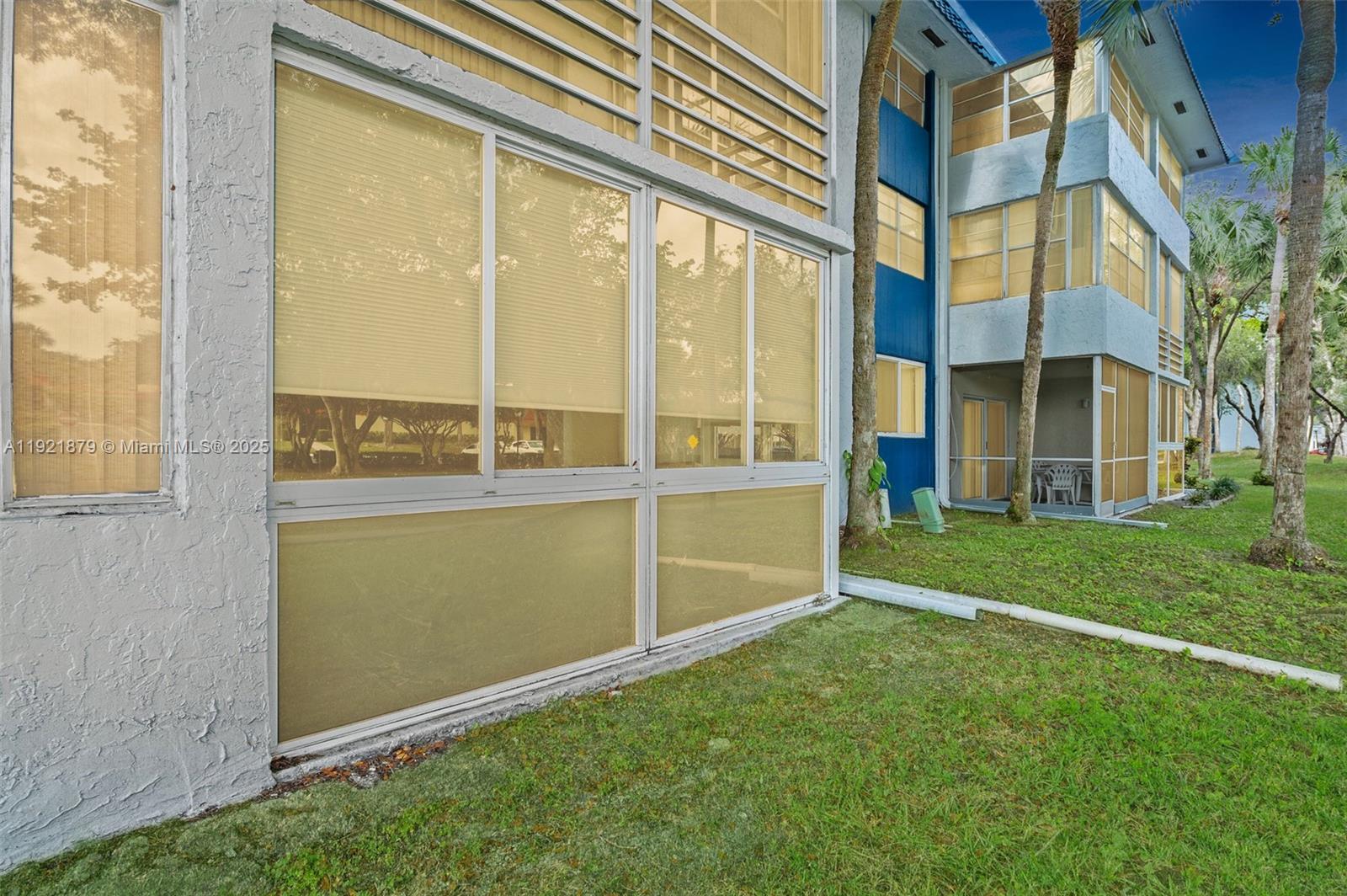 a view of a house with a backyard