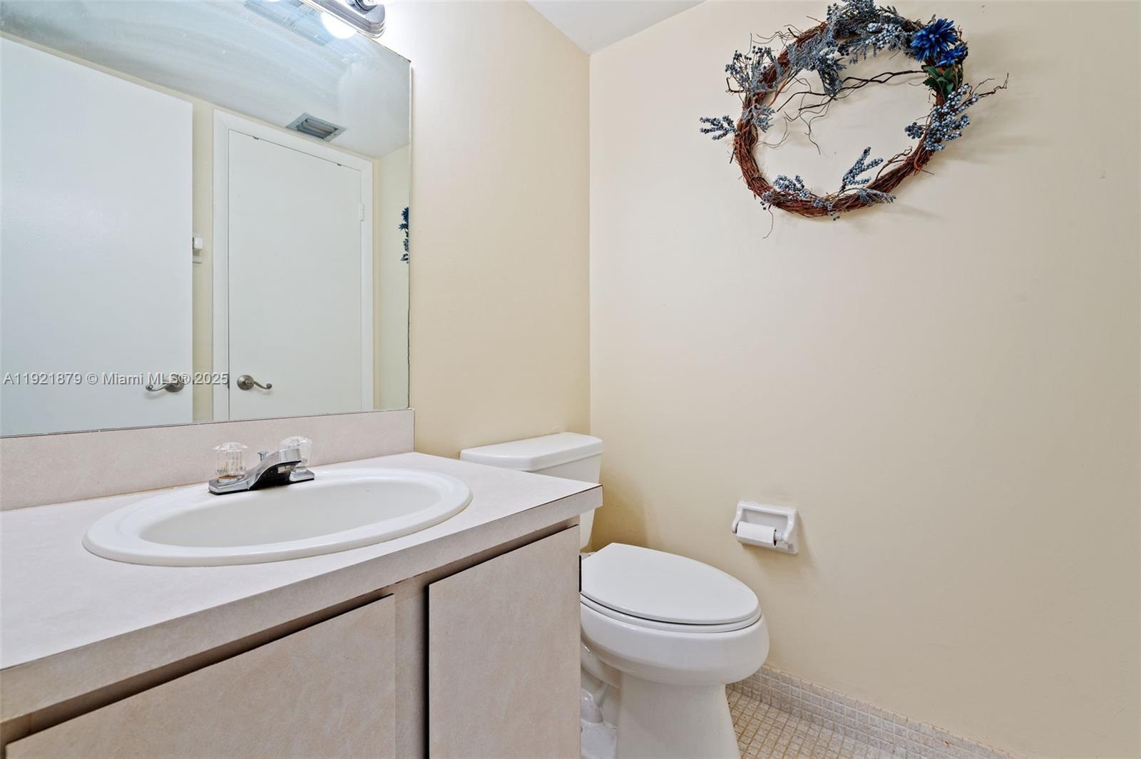 3140 Holiday Springs Boulevard, Unit 9102 Margate, FL 33063 - Photo 11 of 35 a bathroom with a sink a mirror and a toilet