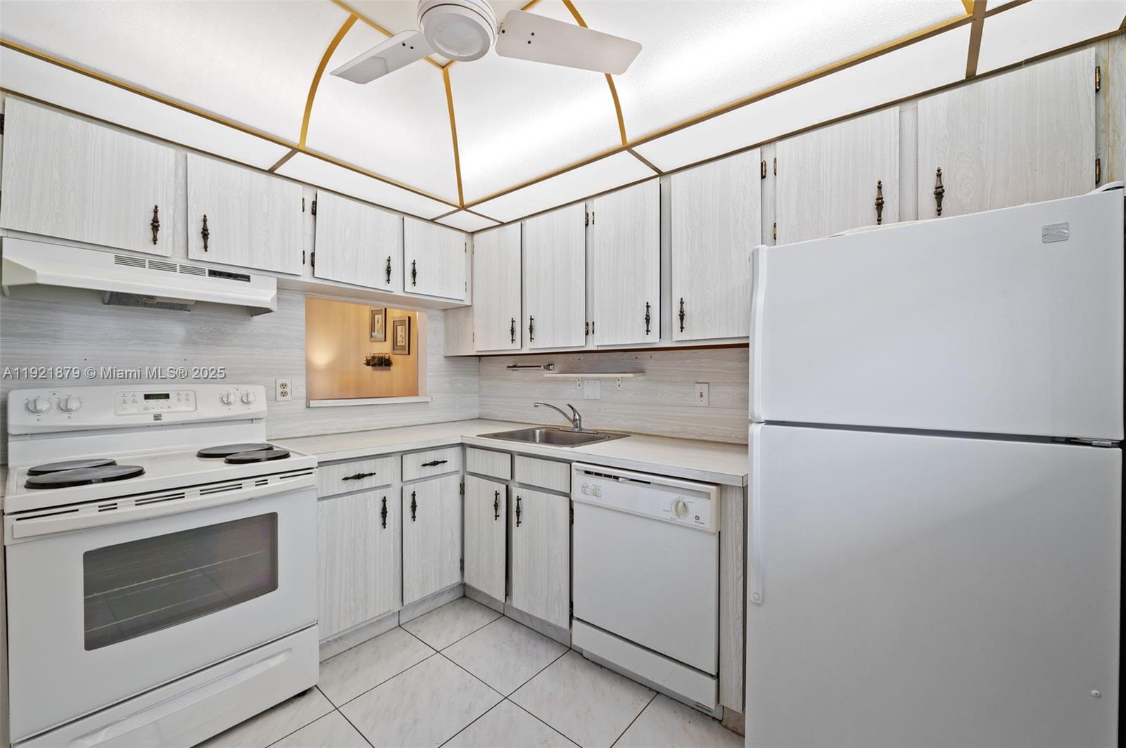 3140 Holiday Springs Boulevard, Unit 9102 Margate, FL 33063 - Photo 19 of 35 a white refrigerator freezer and white cabinets