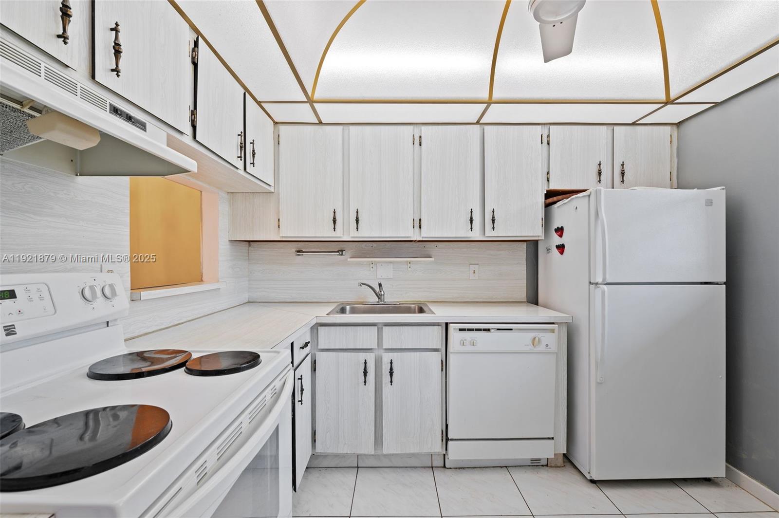 3140 Holiday Springs Boulevard, Unit 9102 Margate, FL 33063 - Photo 20 of 35 a kitchen with a sink a stove and refrigerator