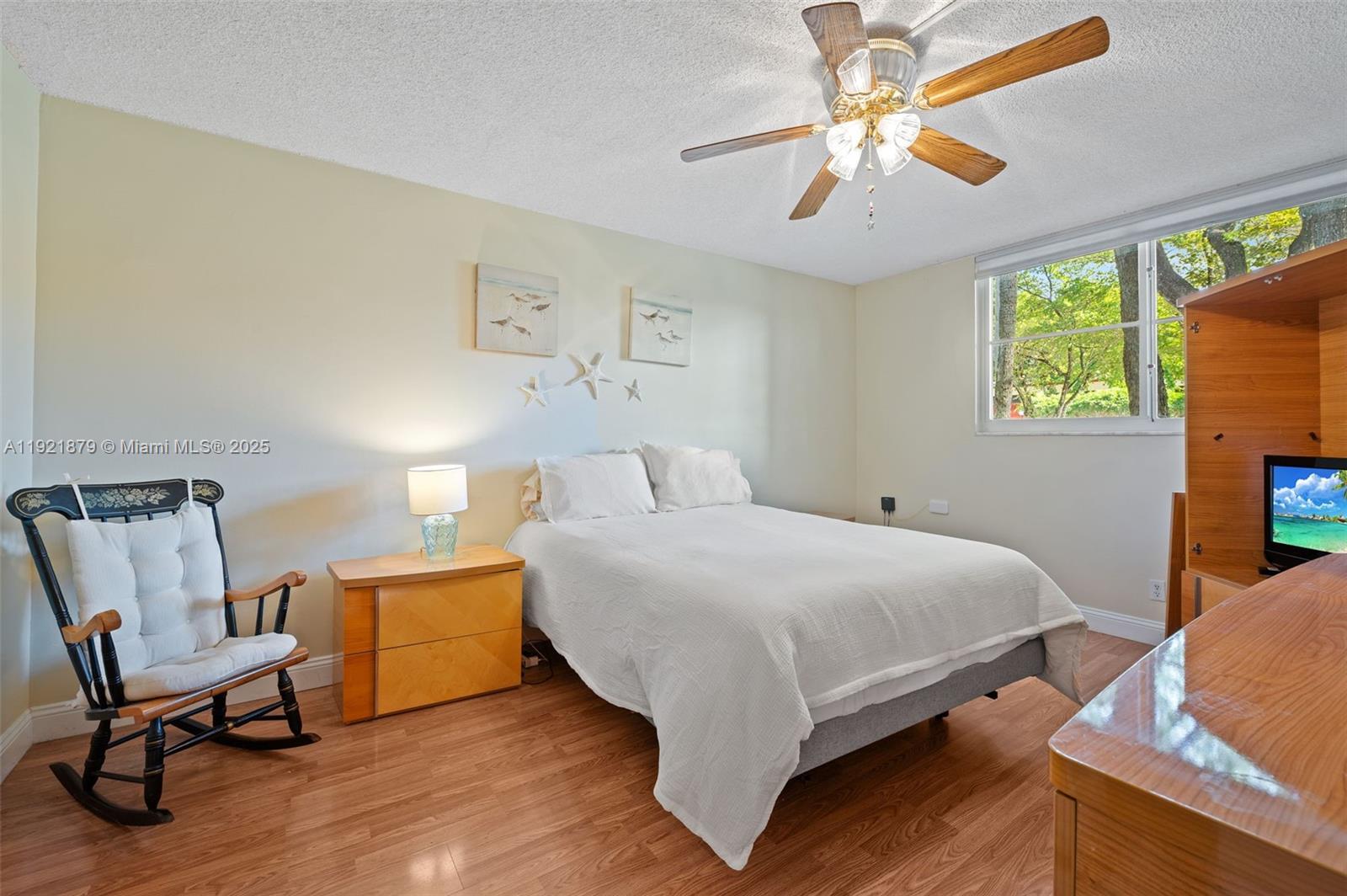 3140 Holiday Springs Boulevard, Unit 9102 Margate, FL 33063 - Photo 22 of 35 a bedroom with a bed and a chair