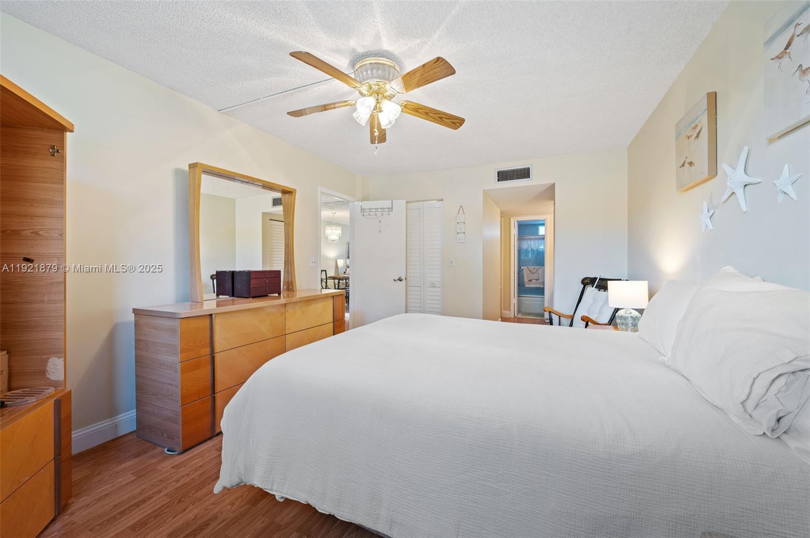3140 Holiday Springs Boulevard, Unit 9102 Margate, FL 33063 - Photo 23 of 35 a bedroom with a large bed and a chandelier