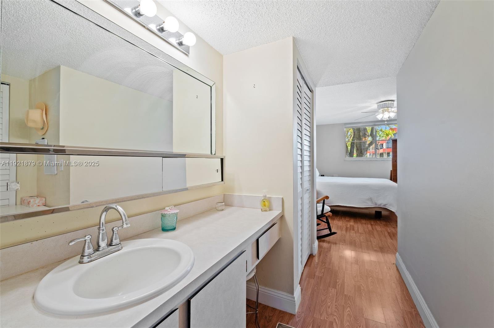 3140 Holiday Springs Boulevard, Unit 9102 Margate, FL 33063 - Photo 25 of 35 a en suite bathroom with a granite countertop double vanity sink and a mirror