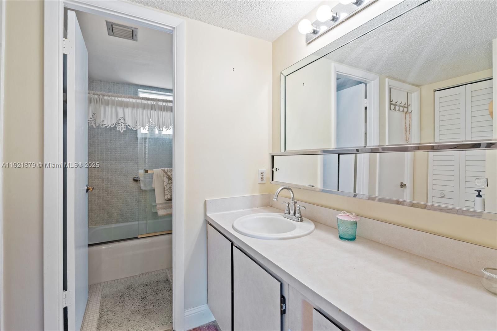 3140 Holiday Springs Boulevard, Unit 9102 Margate, FL 33063 - Photo 26 of 35 a bathroom with a sink and a mirror