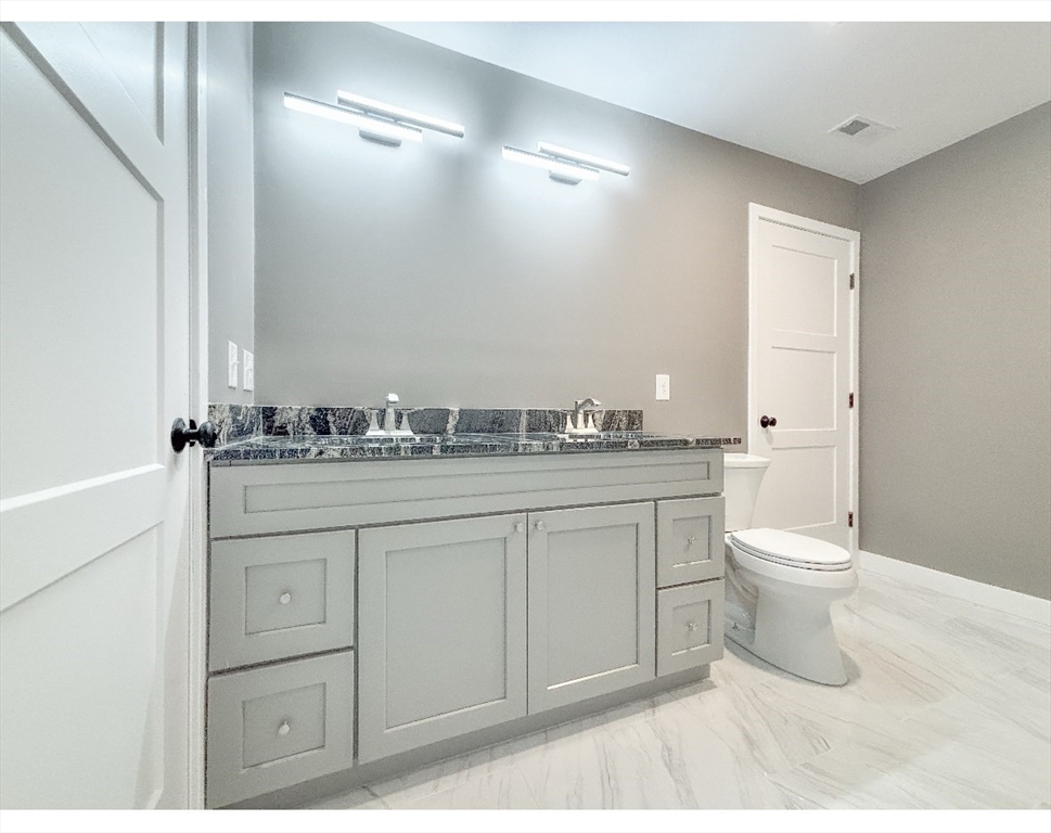 54 Richards Street Worcester, MA 01603 - Photo 16 of 23 a bathroom with a toilet sink and mirror