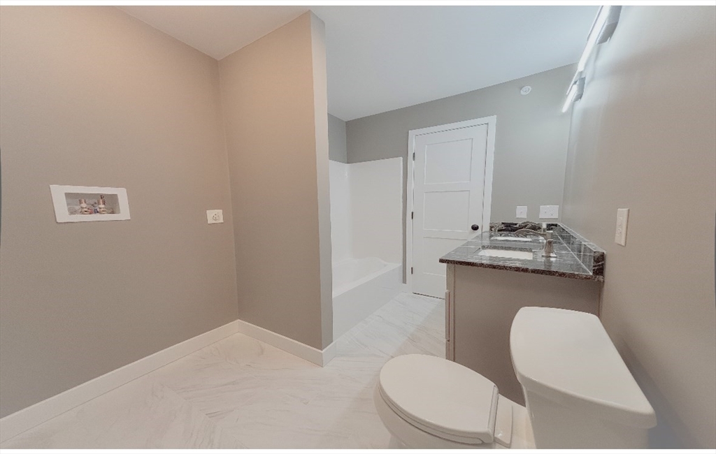 54 Richards Street Worcester, MA 01603 - Photo 17 of 23 a bathroom with a toilet a sink and mirror