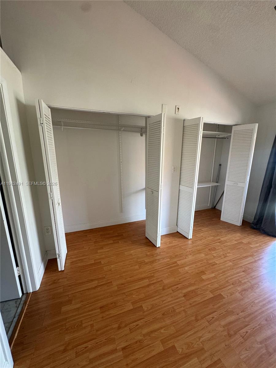10220 Southwest 77th Court Miami, FL 33156 - Photo 12 of 12 a view of an empty room with wooden floor and stairs