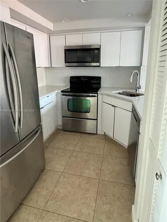 a kitchen with a refrigerator stove and sink