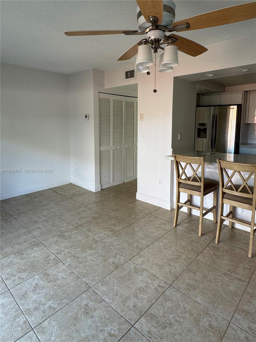 10220 Southwest 77th Court Miami, FL 33156 - Photo 5 of 12 a view of a livingroom with furniture and a ceiling fan