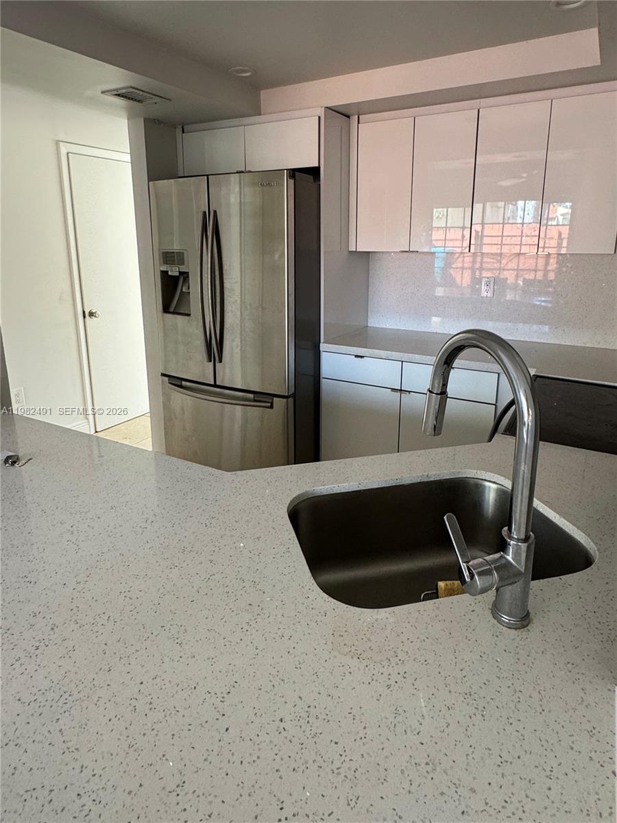 10220 Southwest 77th Court Miami, FL 33156 - Photo 7 of 12 a kitchen with a refrigerator a sink a stove and a window