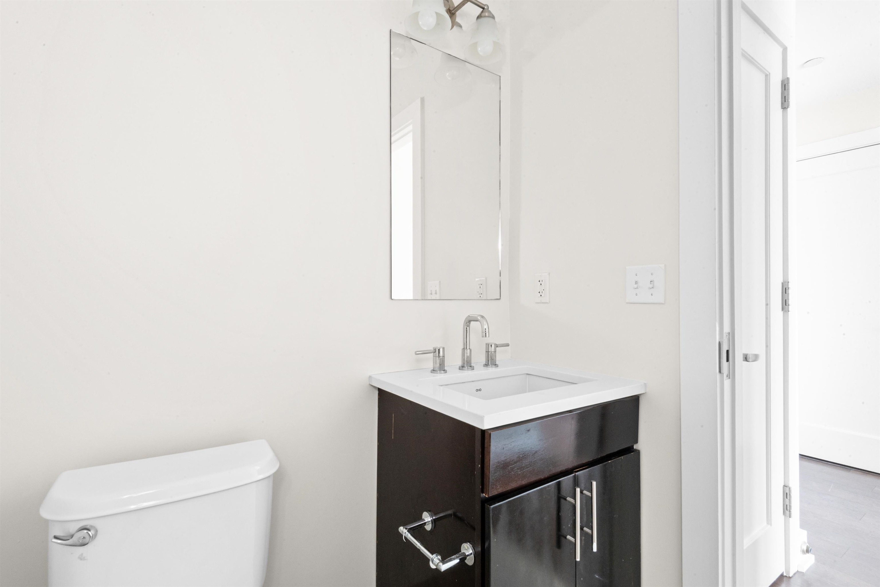 3312 Hudson Avenue, Unit 12F Union City, NJ 07087 - Photo 19 of 32 a bathroom with a sink a toilet and a mirror