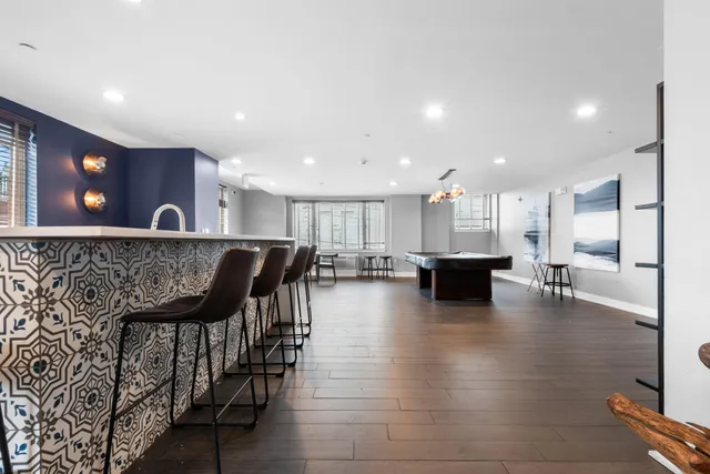 a lobby with furniture and kitchen view