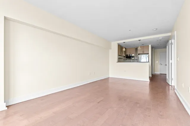 a view of a kitchen with a sink and a refrigerator