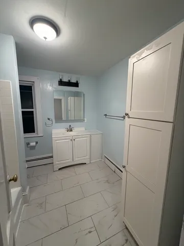 a bathroom with a sink toilet and mirror