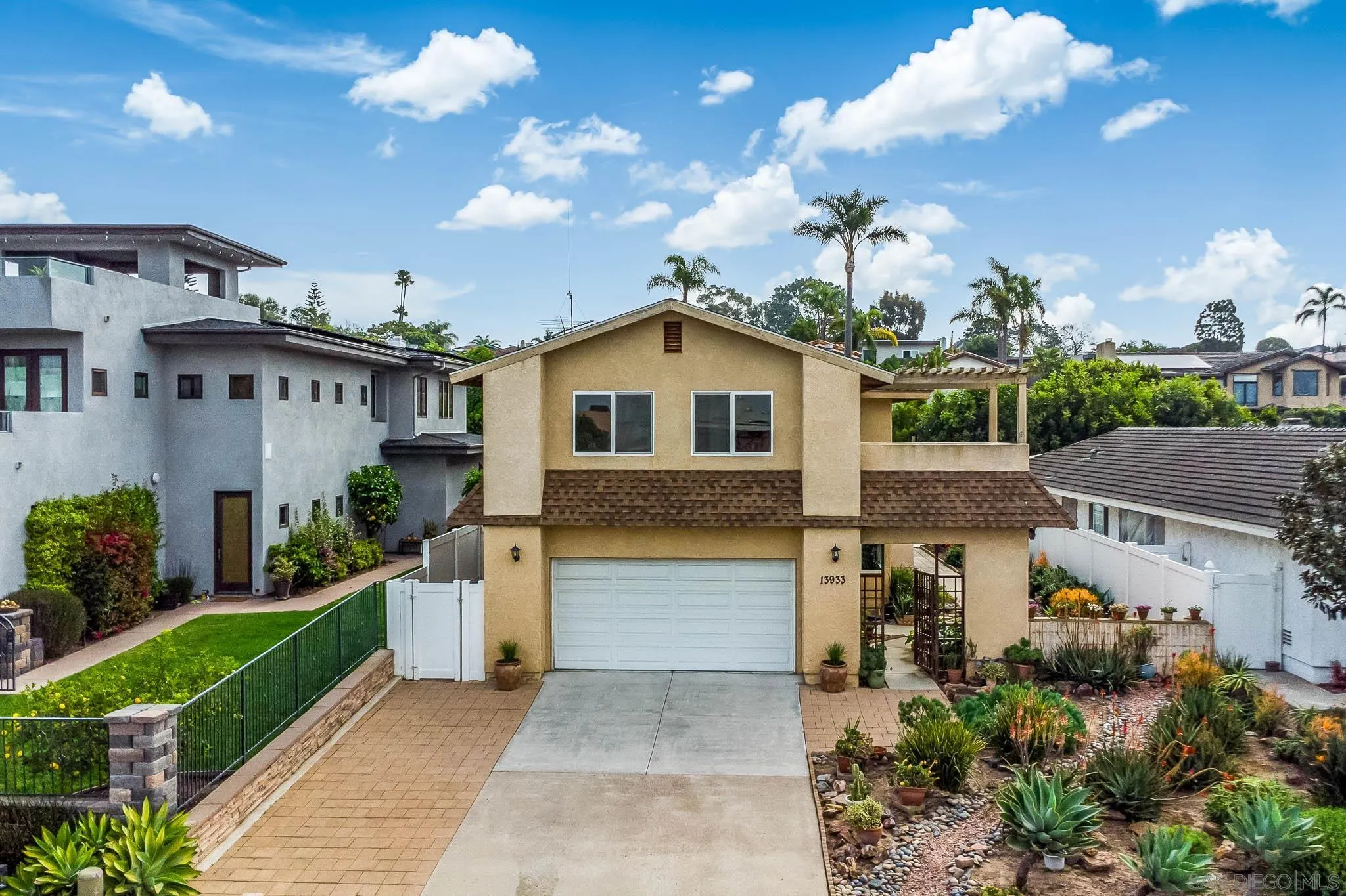 13933 Recuerdo Drive Del Mar, CA 92014 - Photo 2 of 44 a front view of a house with a yard and potted plants