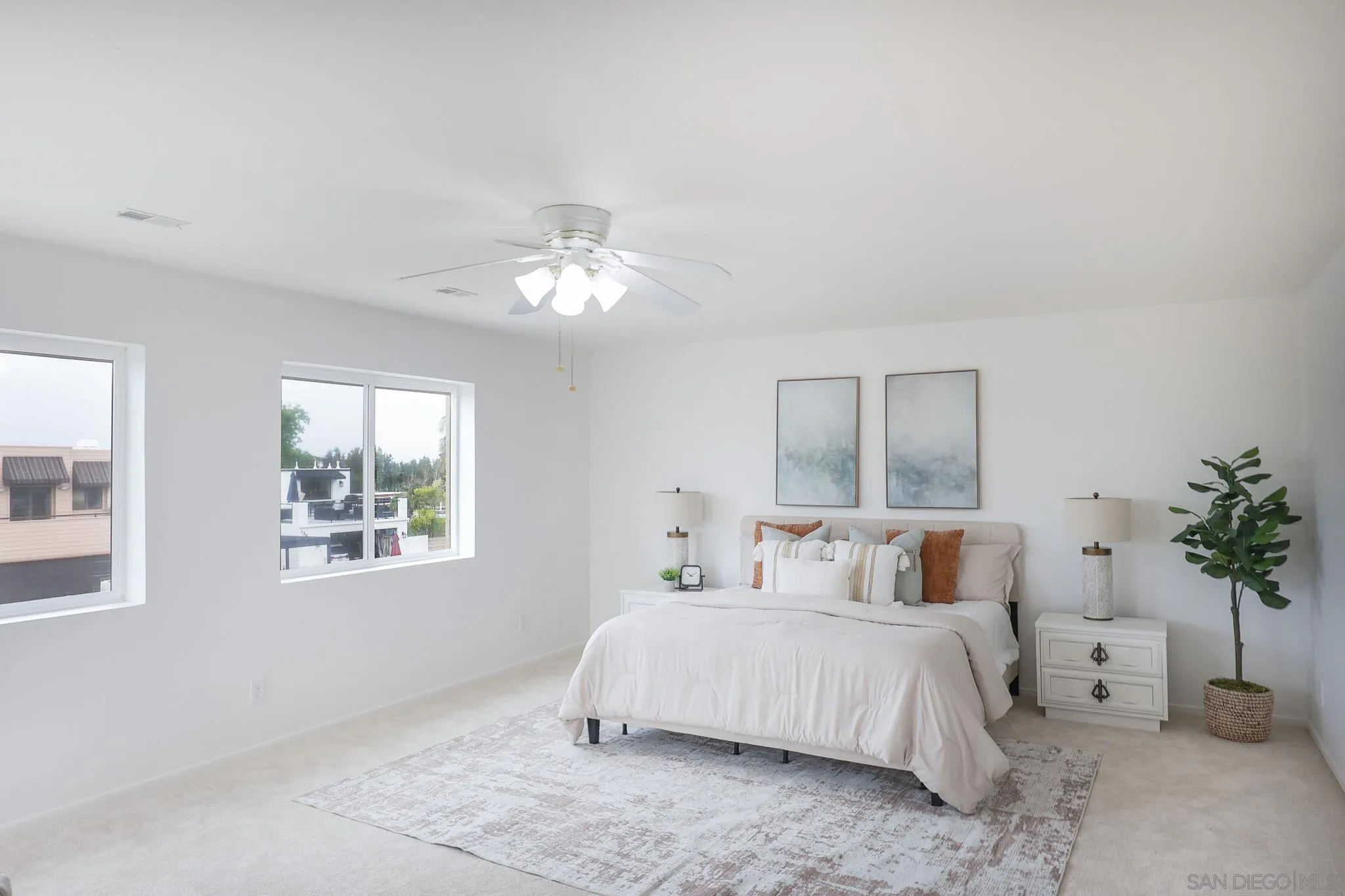13933 Recuerdo Drive Del Mar, CA 92014 - Photo 24 of 44 a bedroom with a large bed and a chandelier