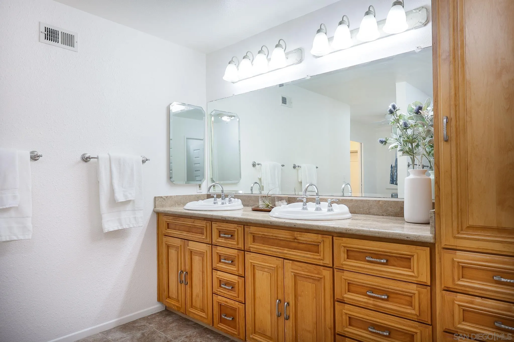 13933 Recuerdo Drive Del Mar, CA 92014 - Photo 27 of 44 a bathroom with a sink vanity granite and a mirror
