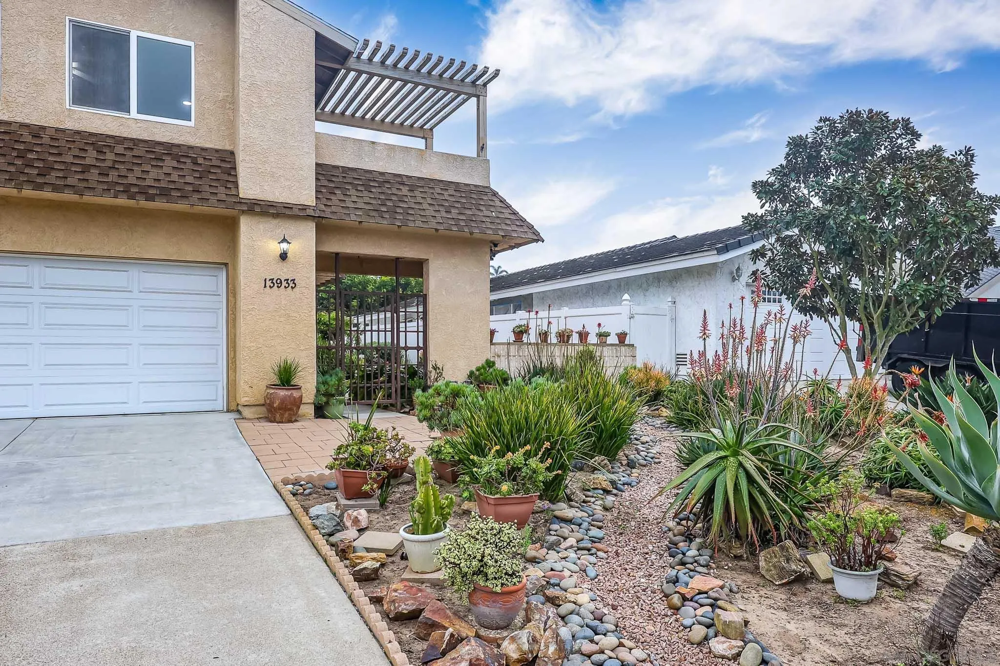 13933 Recuerdo Drive Del Mar, CA 92014 - Photo 3 of 44 a front view of a house with a garden