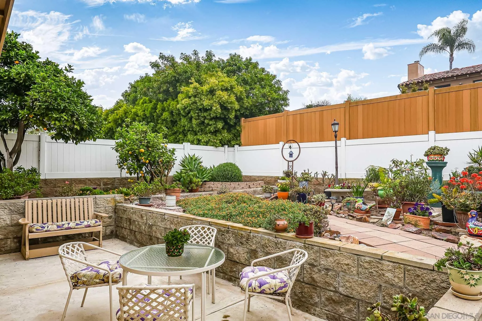 13933 Recuerdo Drive Del Mar, CA 92014 - Photo 36 of 44 a view of a patio with couches table and chairs and potted plants