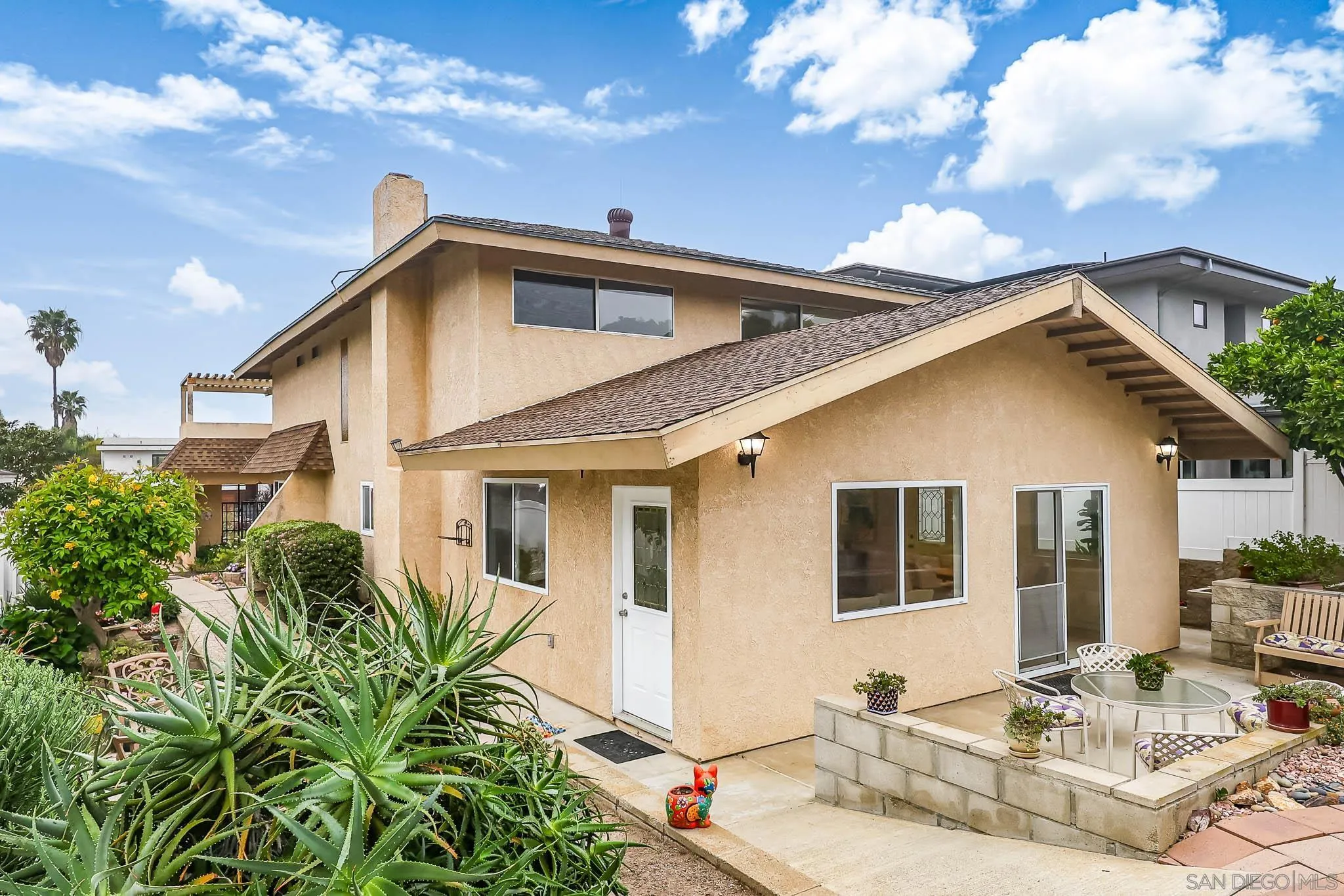 13933 Recuerdo Drive Del Mar, CA 92014 - Photo 38 of 44 a view of a white house with a large windows and couches chairs with wooden floor
