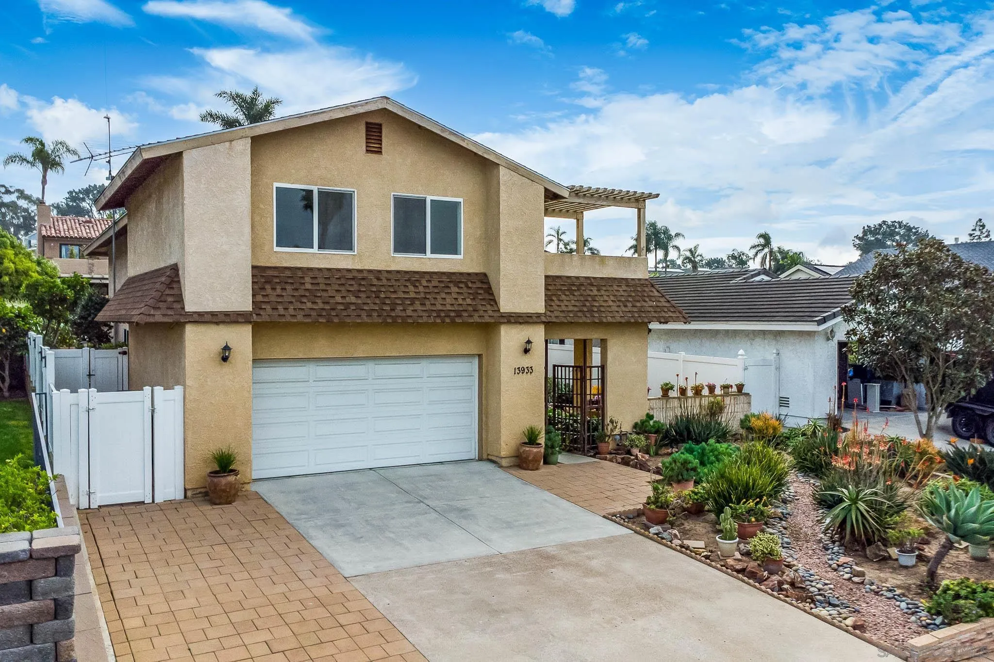 13933 Recuerdo Drive Del Mar, CA 92014 - Photo 41 of 44 a front view of a house with a yard and garage