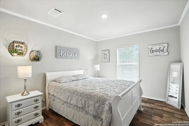 a bedroom with a large bed and a window