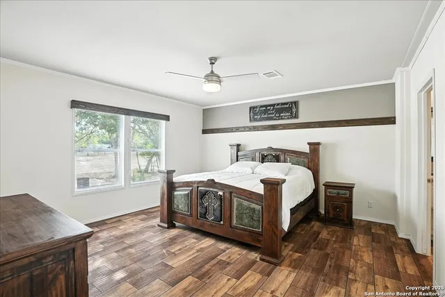 a view of bedroom with furniture and a flat screen tv