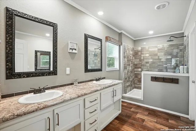 a bathroom with double sink and a mirror