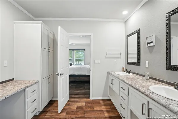 a spacious bathroom with a granite countertop sink mirror and double
