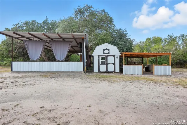 a view of a house with wooden fence