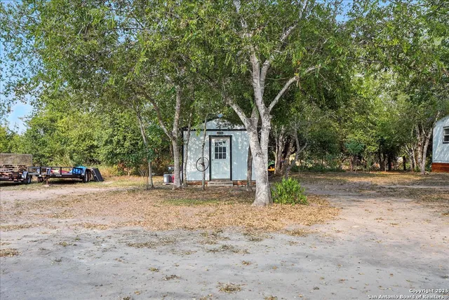a view of road space with large trees