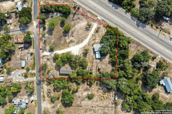 an aerial view of a house with a yard