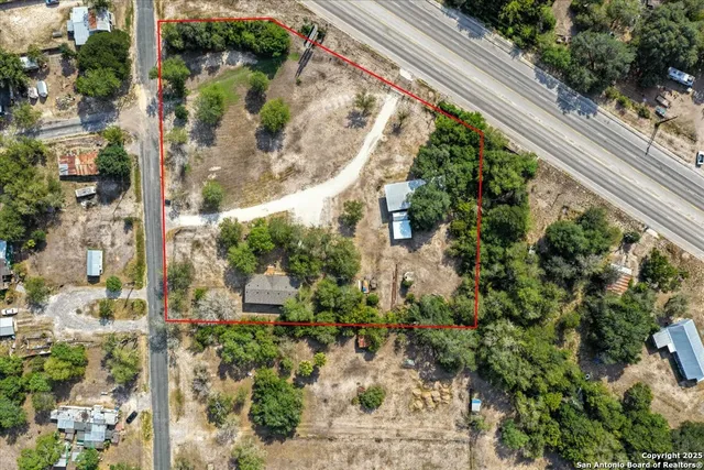 an aerial view of a house with a yard