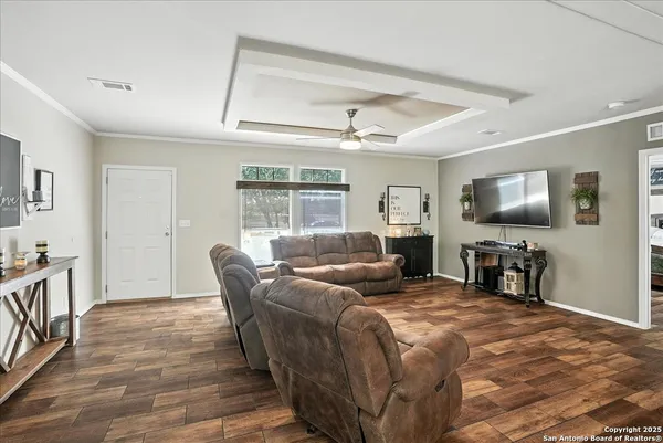 a bedroom with furniture and a flat screen tv
