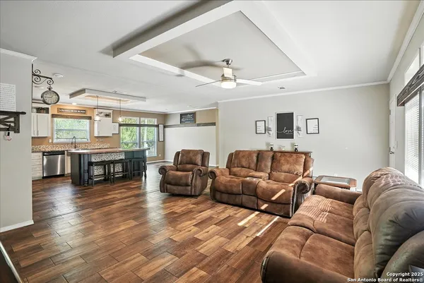 a living room with furniture and wooden floor