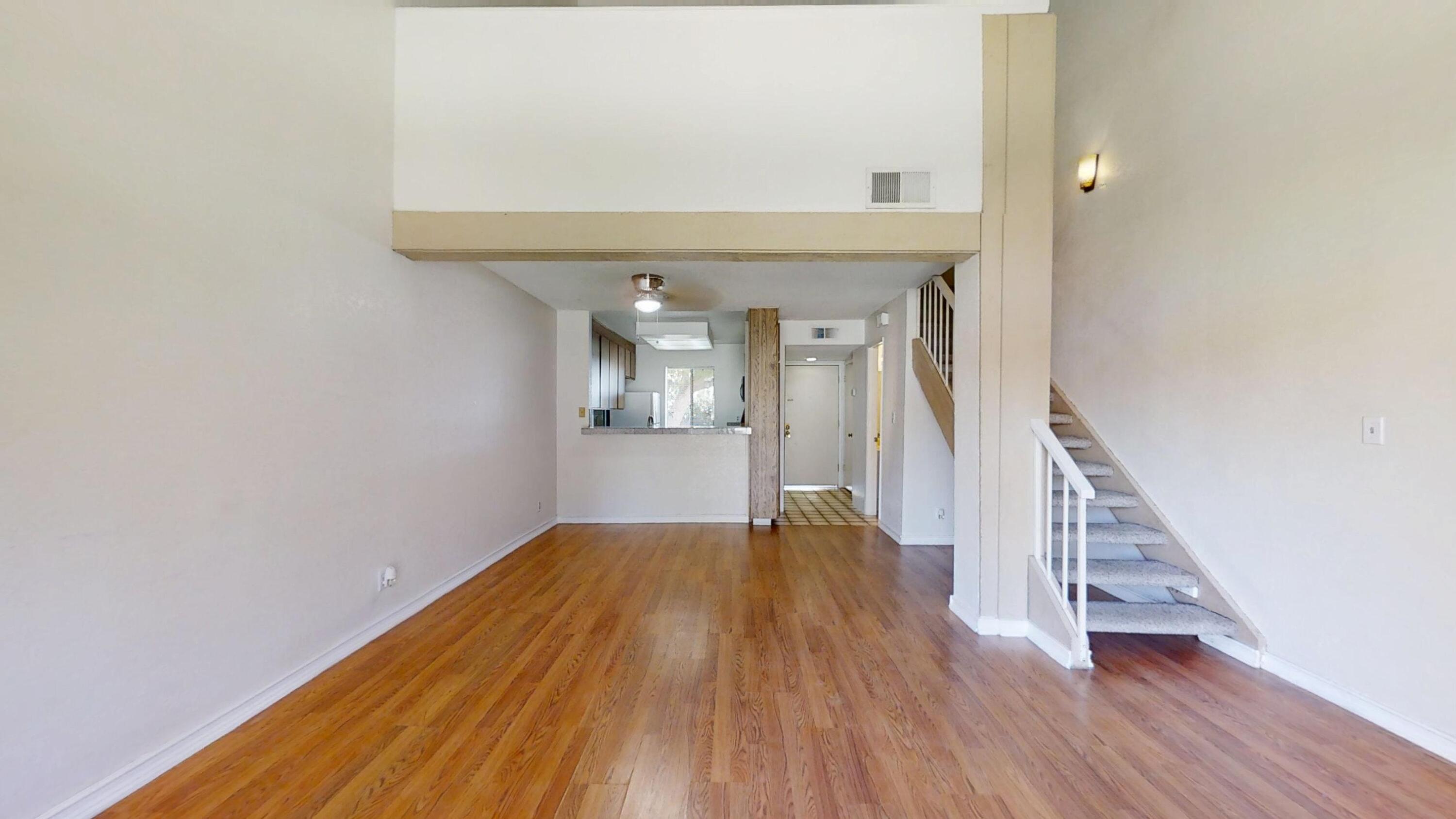 48255 Monroe Street, Unit 2 Indio, CA 92201 - Photo 11 of 35 a view of a hallway with wooden floor and staircase