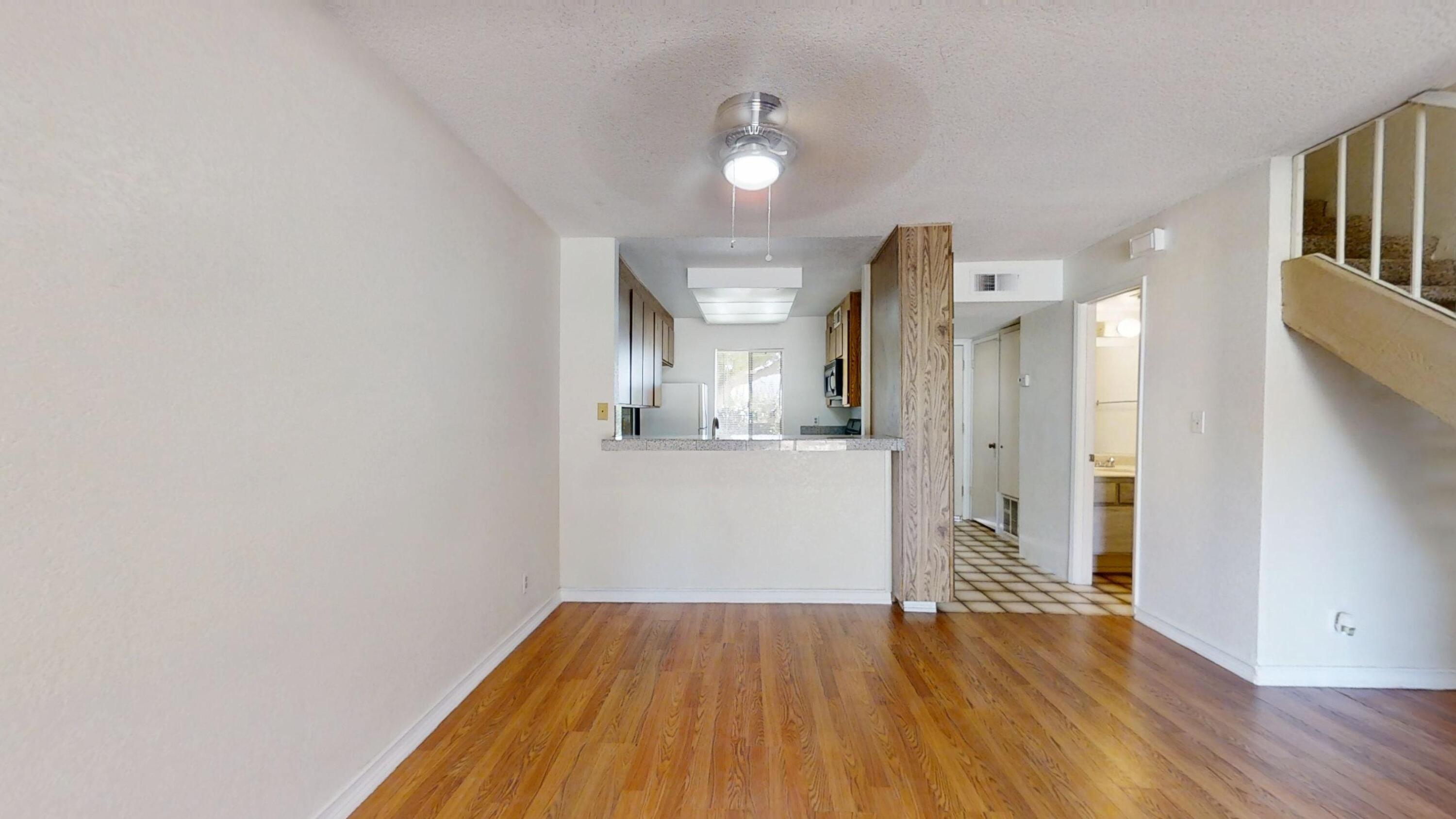 48255 Monroe Street, Unit 2 Indio, CA 92201 - Photo 13 of 35 a view of a hallway with wooden floor and a kitchen