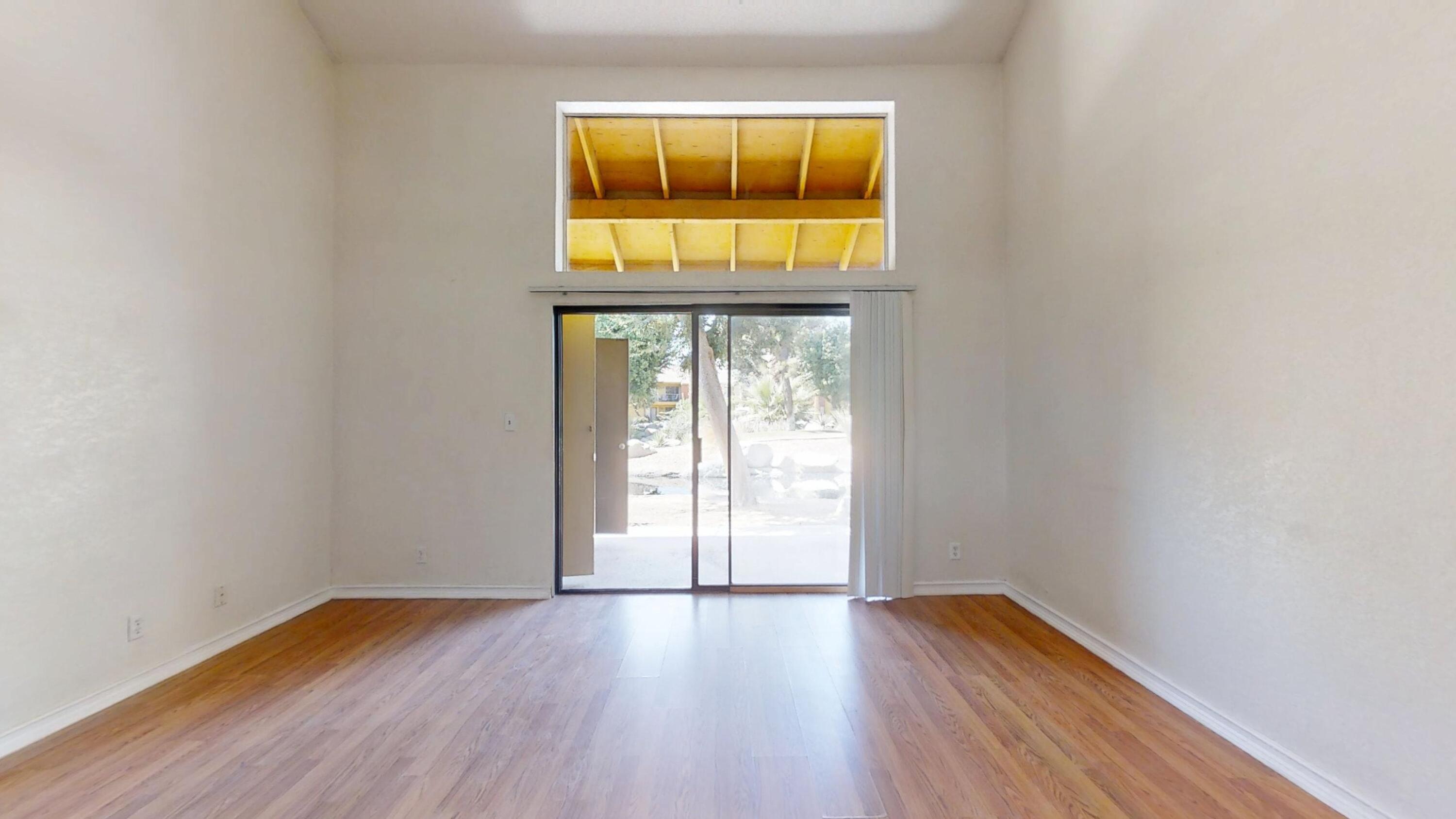 48255 Monroe Street, Unit 2 Indio, CA 92201 - Photo 15 of 35 an empty room with wooden floor and windows
