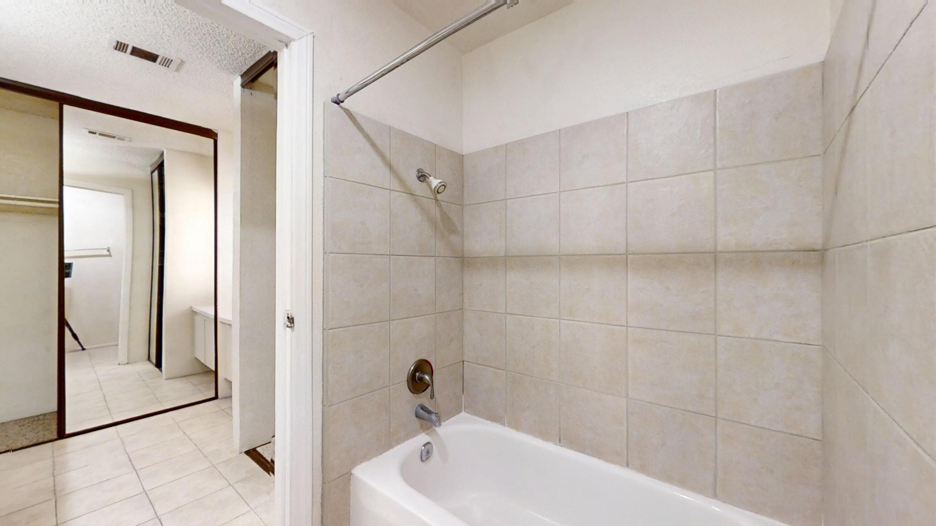 48255 Monroe Street, Unit 2 Indio, CA 92201 - Photo 22 of 35 a bathroom with a bathtub and a shower