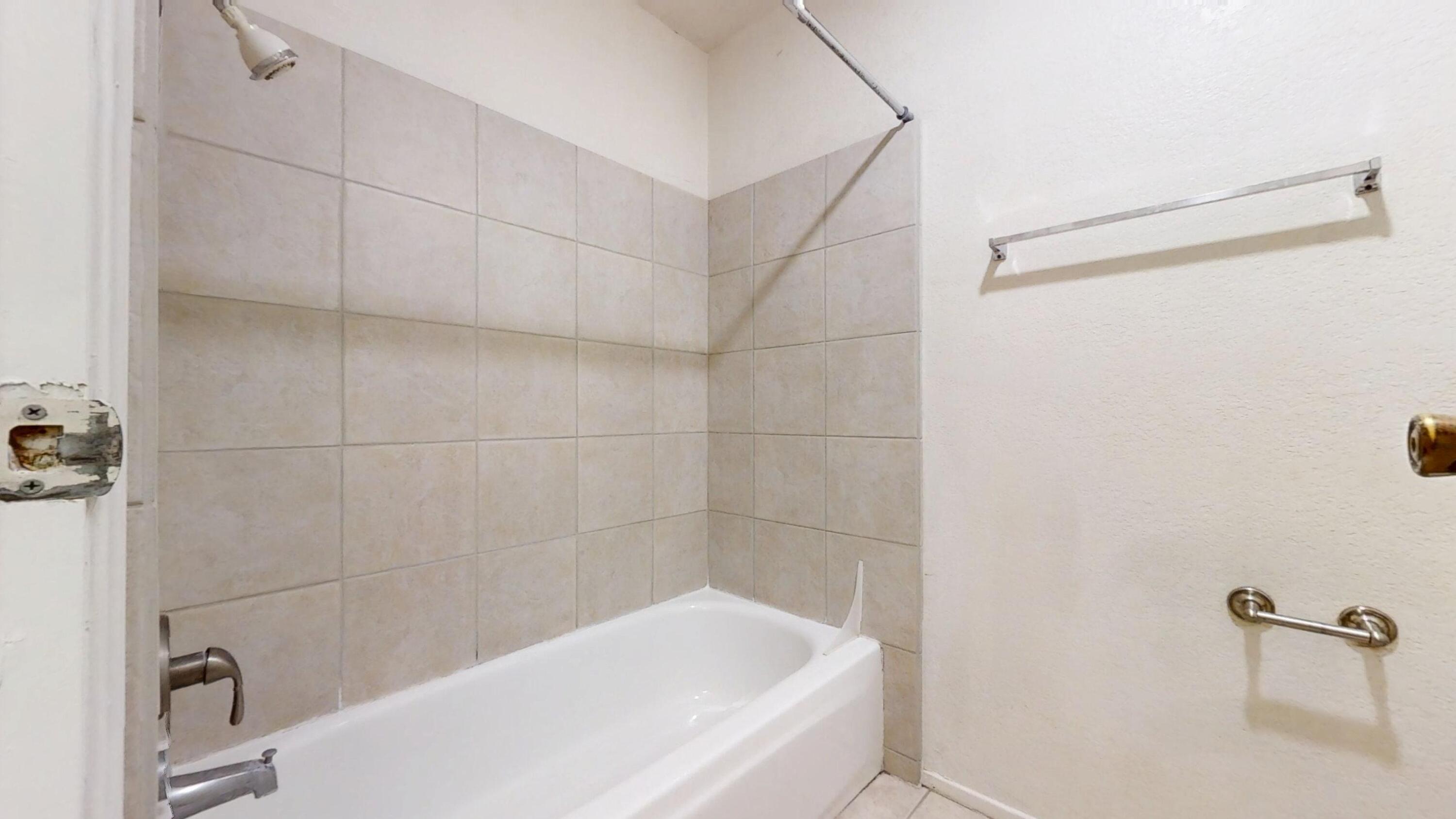 48255 Monroe Street, Unit 2 Indio, CA 92201 - Photo 23 of 35 a bathroom with a bathtub and a shower
