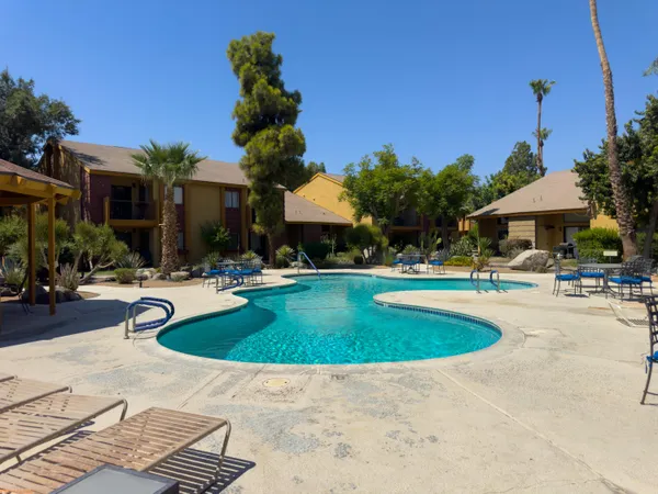 a view of a swimming pool with a table and chairs