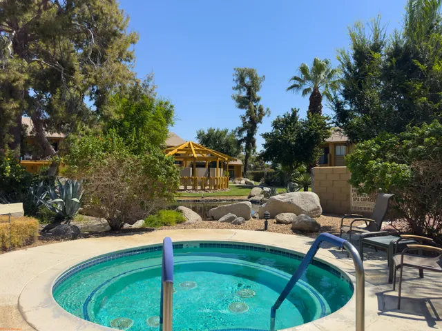 a swimming pool with outdoor seating and yard