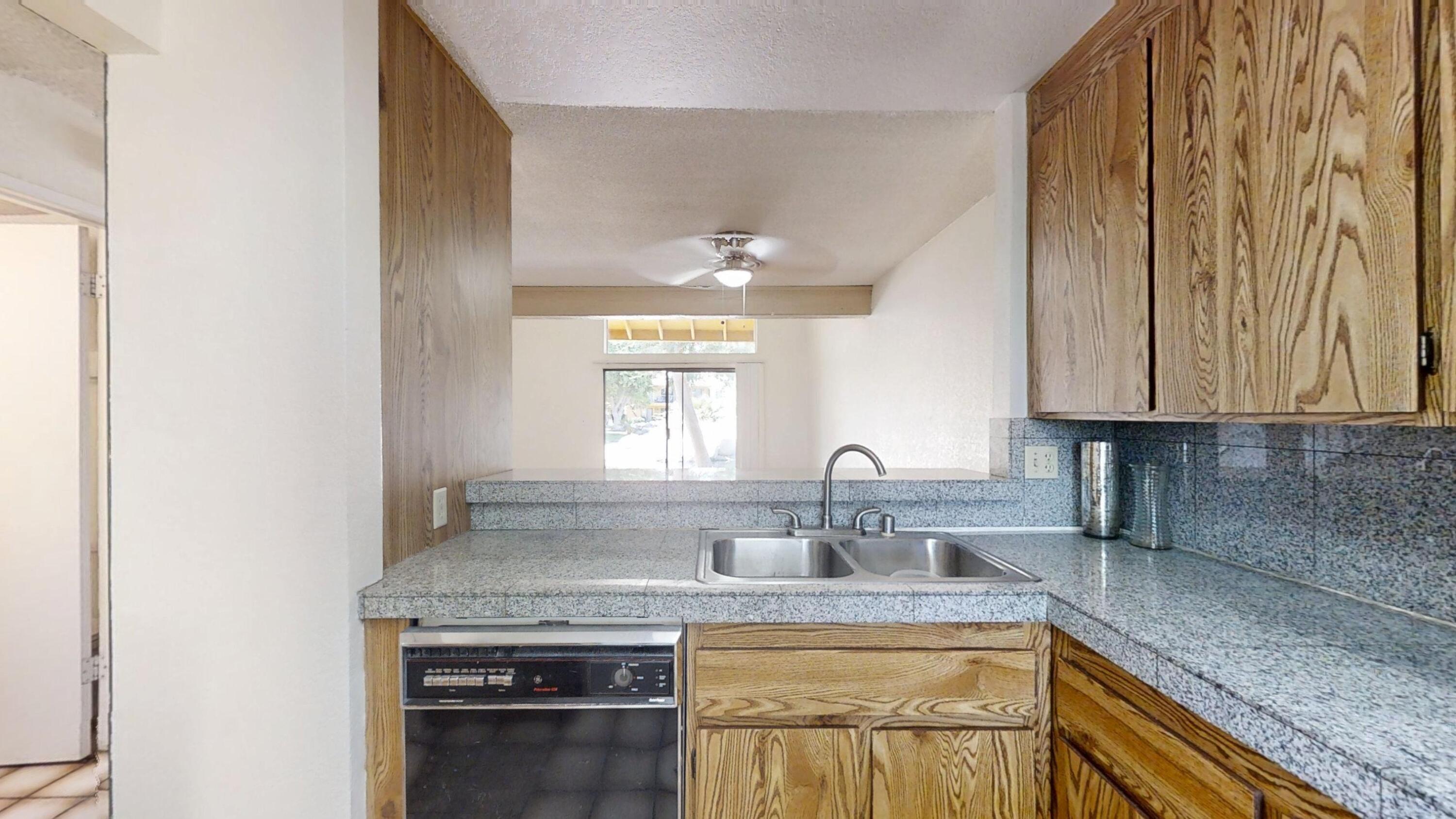 48255 Monroe Street, Unit 2 Indio, CA 92201 - Photo 7 of 35 a kitchen with stainless steel appliances granite countertop a sink stove and cabinets
