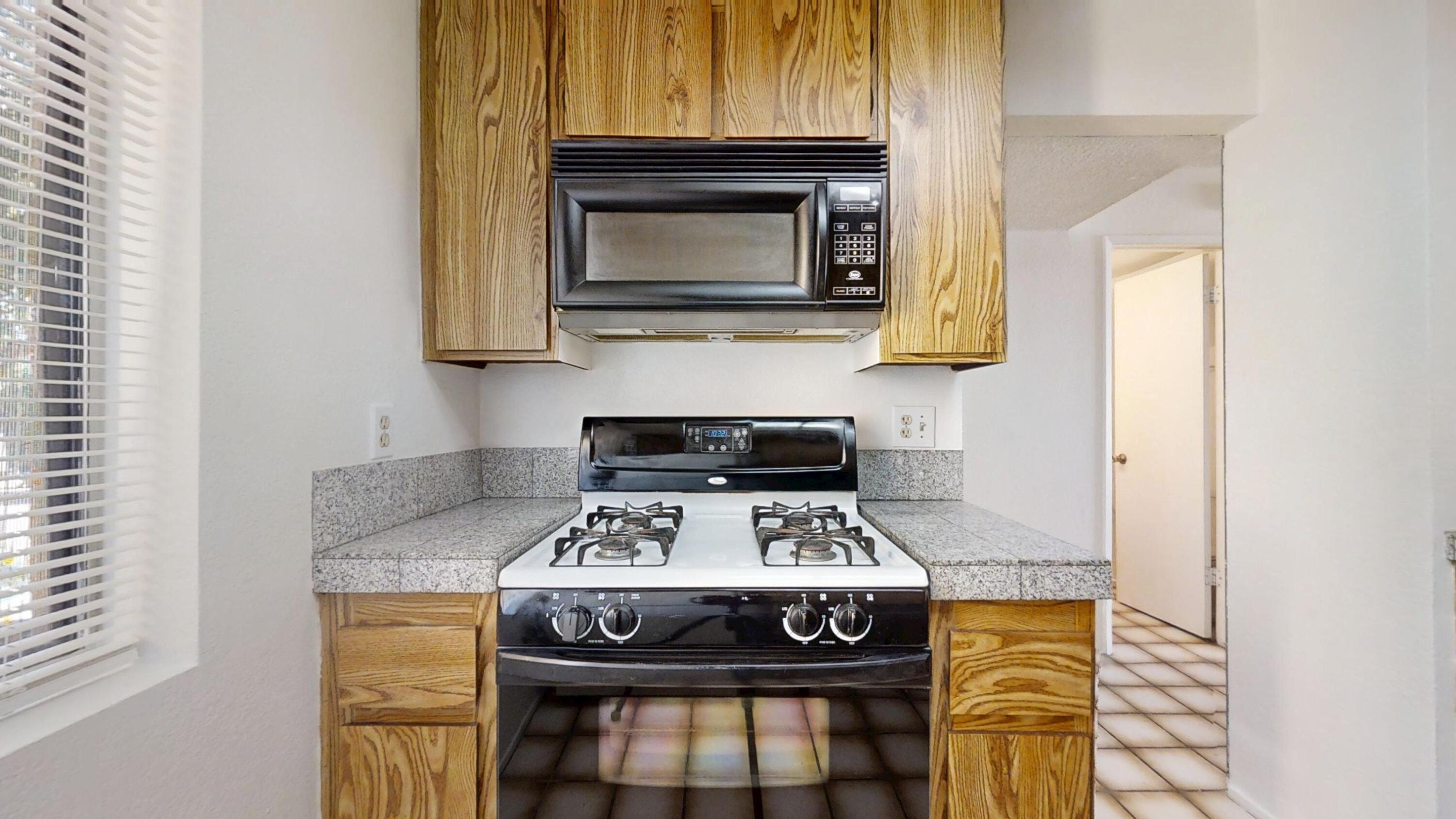 48255 Monroe Street, Unit 2 Indio, CA 92201 - Photo 8 of 35 a kitchen with a stove and a microwave