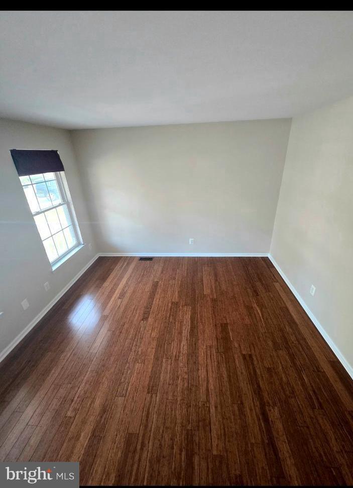 644 Surrey Road Sewell, NJ 08080 - Photo 34 of 37 a view of an empty room with wooden floor and a window