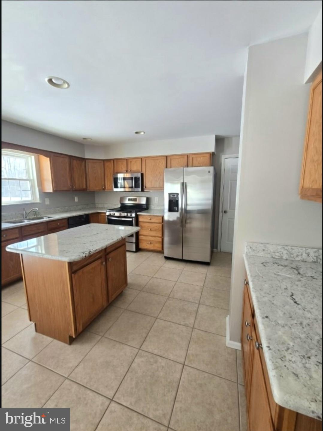 644 Surrey Road Sewell, NJ 08080 - Photo 5 of 37 a kitchen with stainless steel appliances granite countertop a sink stove and a refrigerator