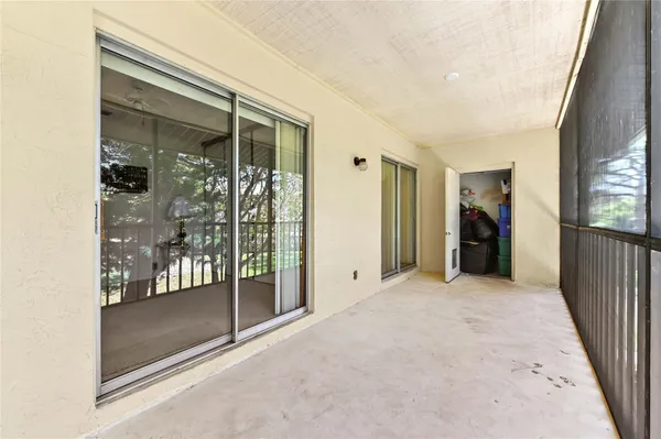 a view of a hallway with wooden floor and a glass door