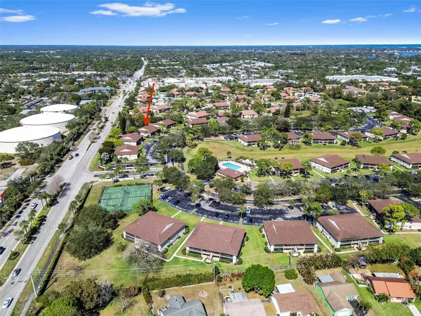 an aerial view of residential houses with outdoor space