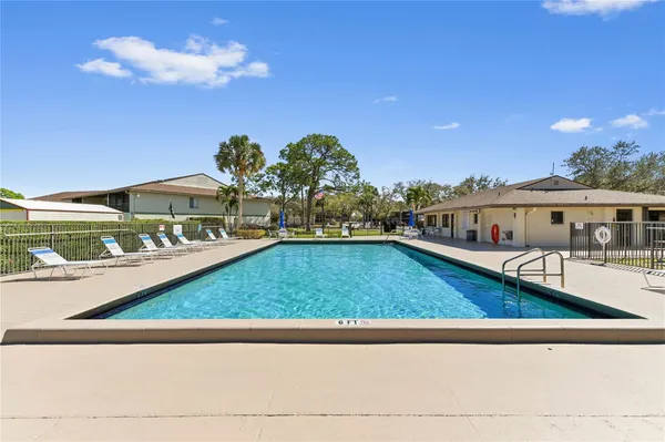 a swimming pool view with a garden space